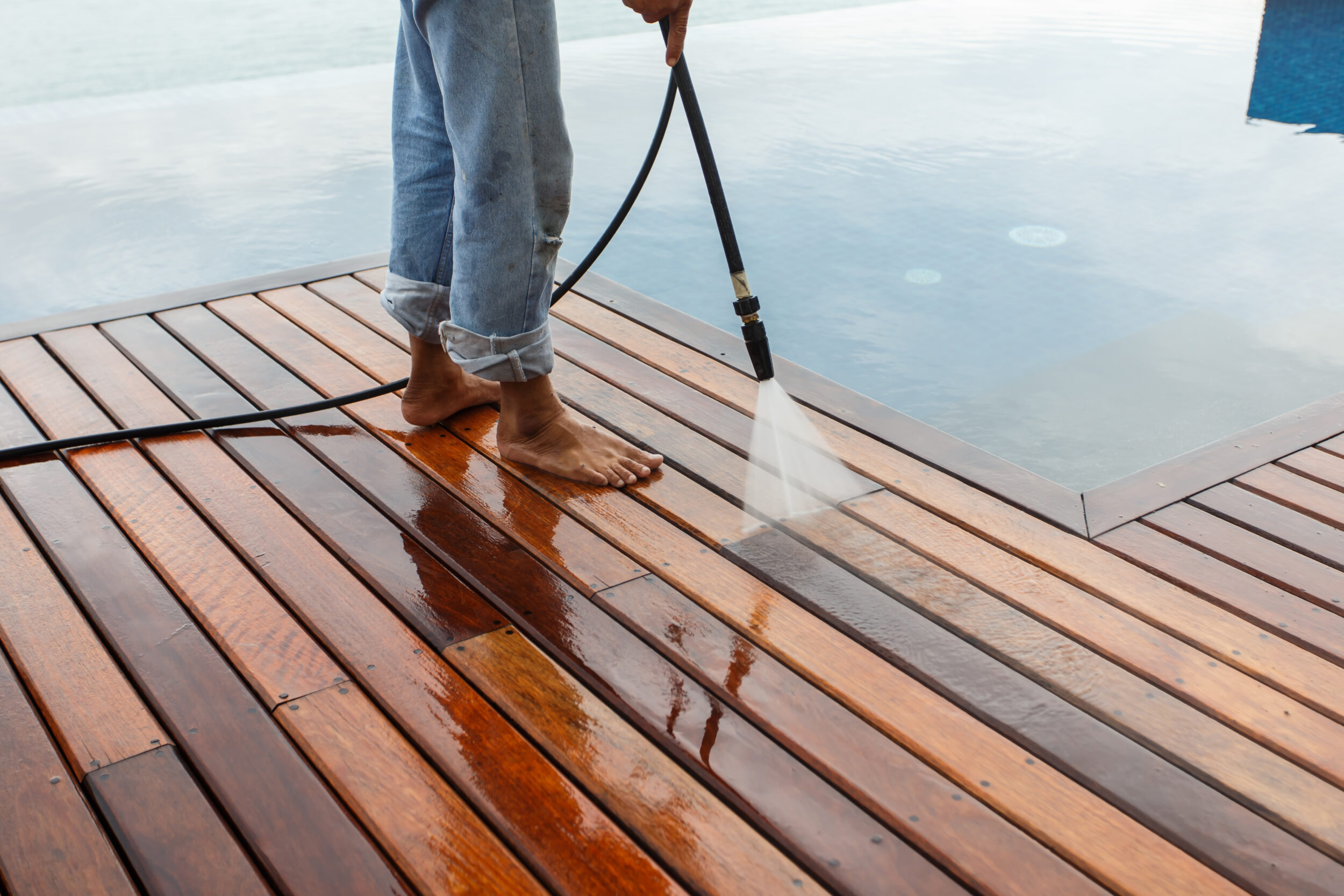 Thai Man Do A Pressure Washing On Timber